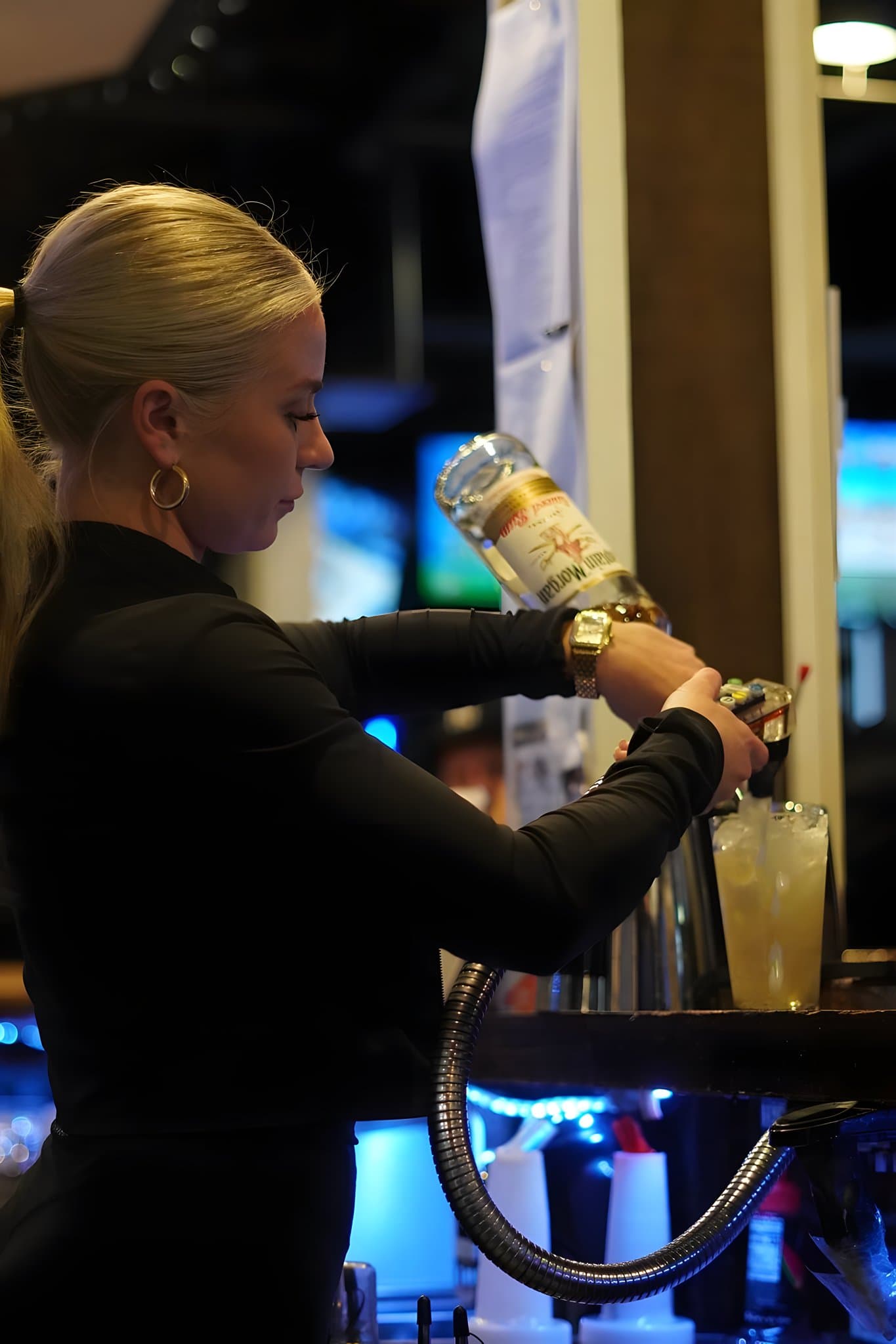 A Canz bartender pouring a cocktail