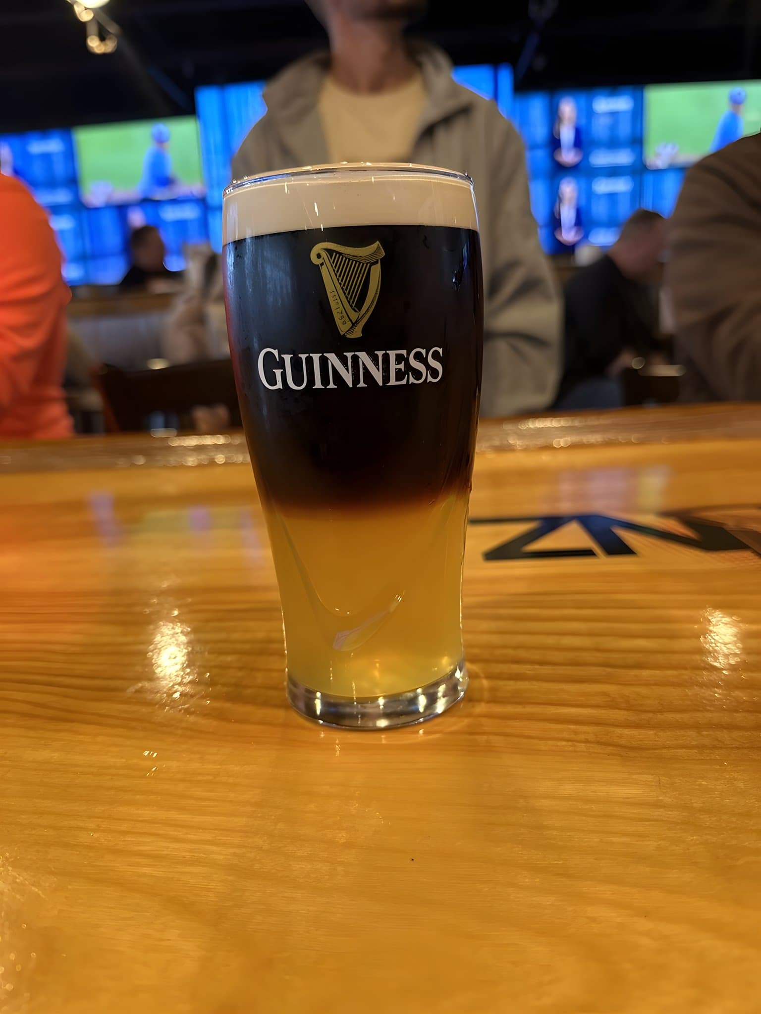 A pint of Guinness settling on the bar