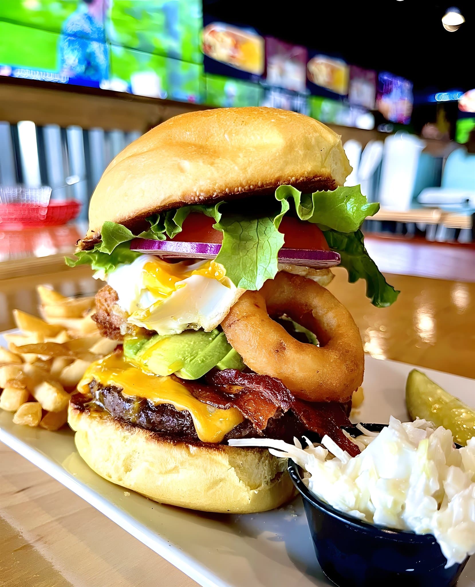 Canz burger with bacon and an onion ring