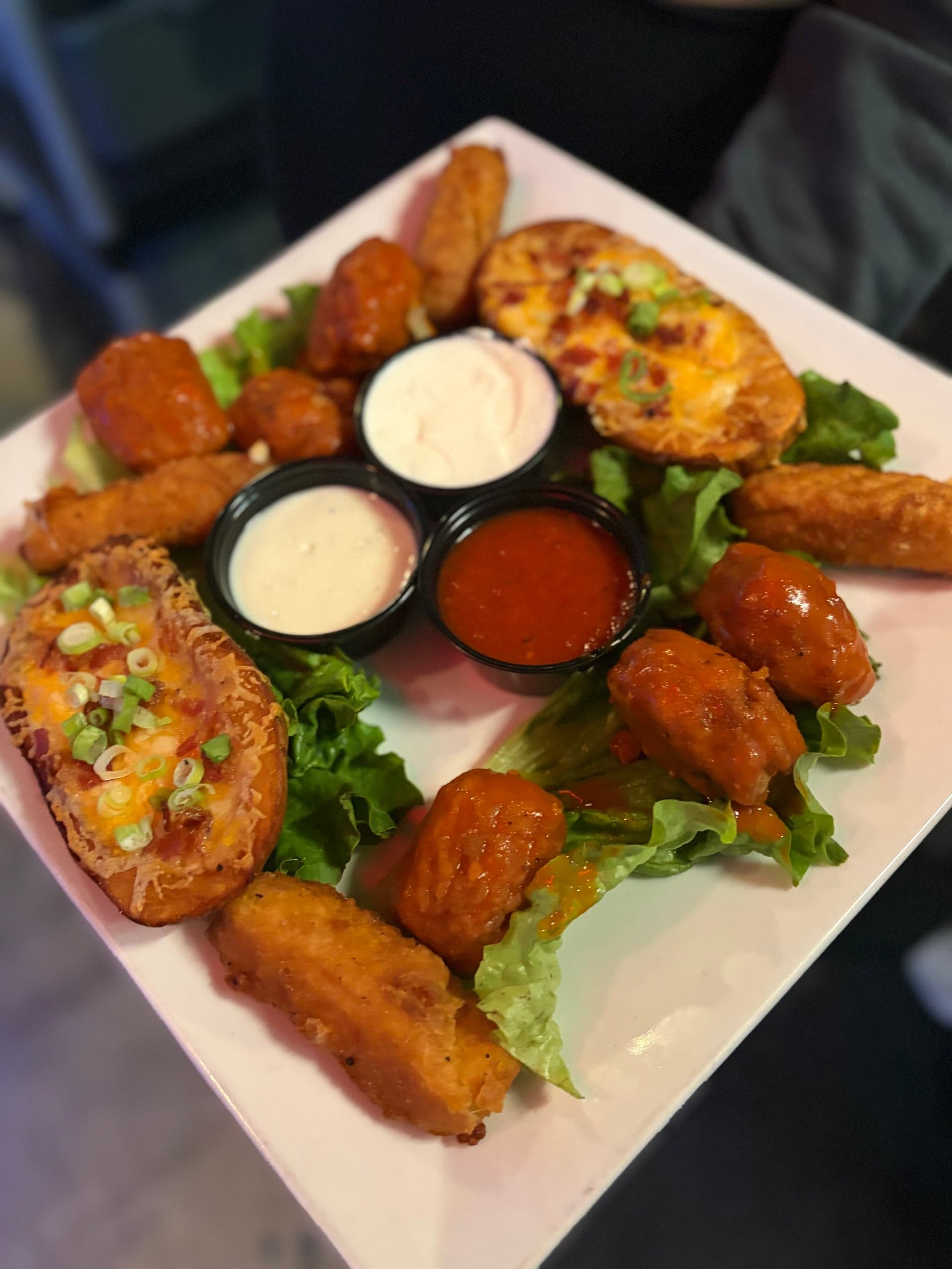 Sampler platter of loaded potato skinz, buffalo bitez and mozzarella stickz with ranch, blue cheese and marinara.